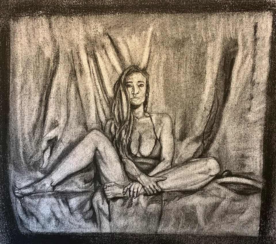 Charcoal figure study of a seated woman against drapery
