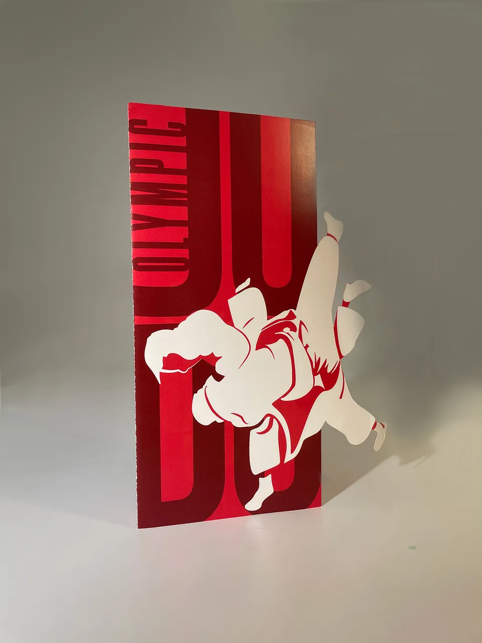 Paris 2024 judo brochure cover in red