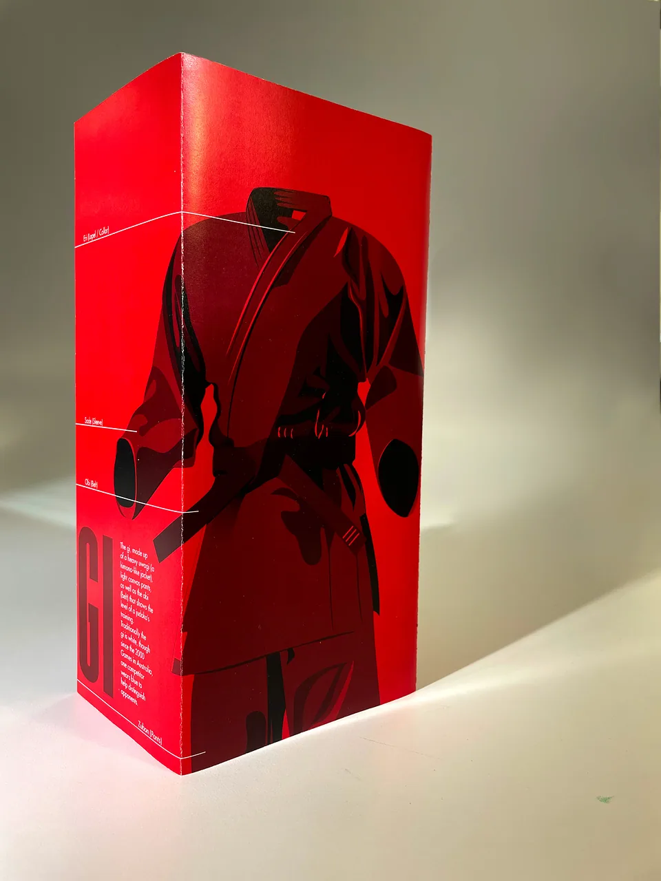 Red informative sculpture featuring a judogi silhouette